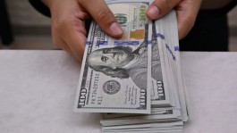 The dollar hits a two-month high as Federal Reserve expectations dominate markets.