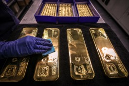 Gold retreats after hitting record levels